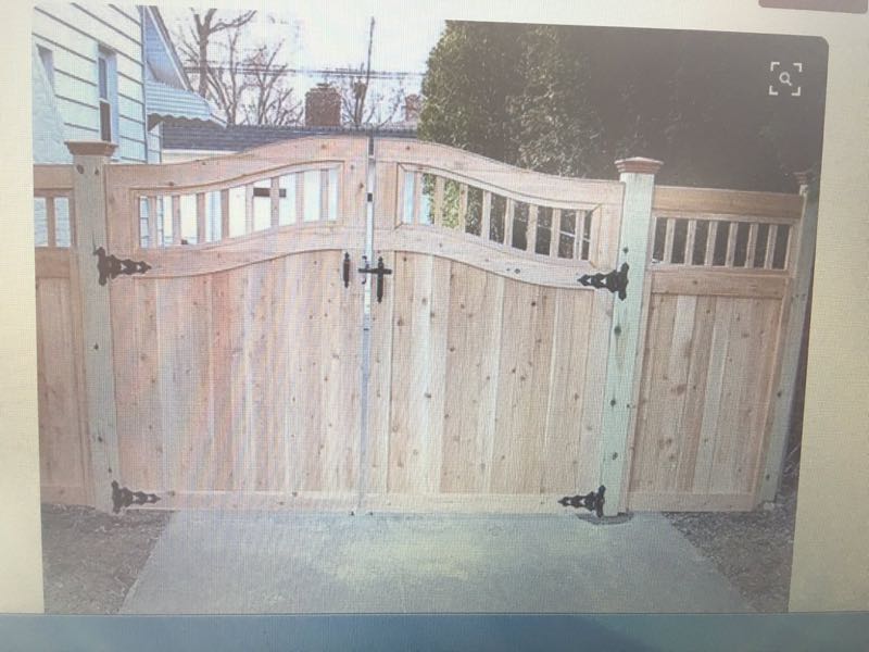 Cedar fence with a pair of arched wooden gates