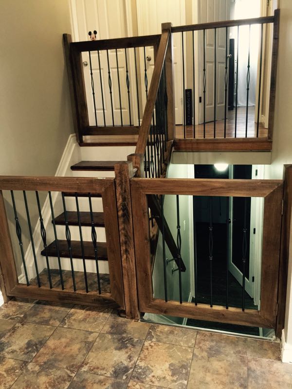 Stairwell with dark-stained wood railings and black metal spindles